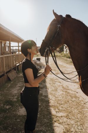 Woman kissing horse on ranch