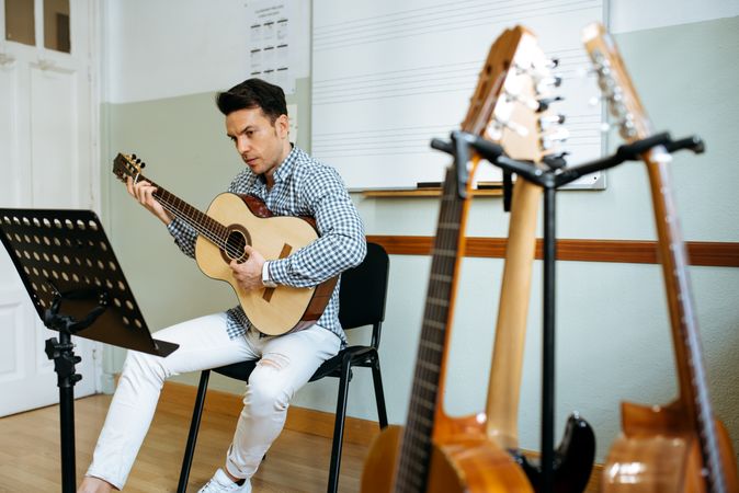 Man playing guitar in studio
