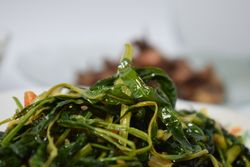 Plate of cooked greens side dish on table