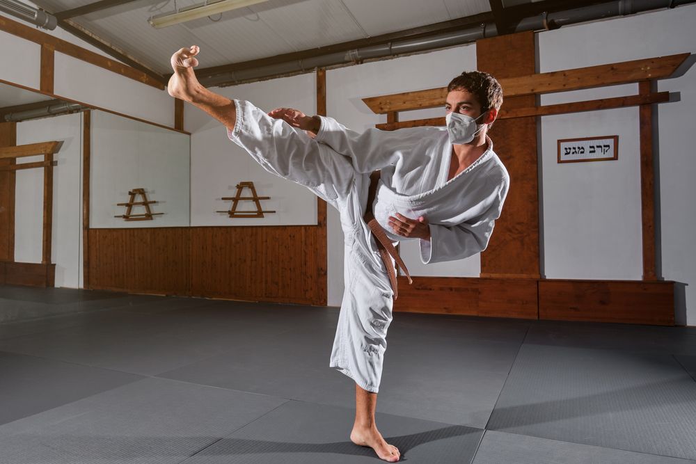 Male in mask demonstrating Krav Maga pose