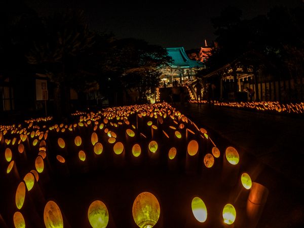 Lit lantern on street during night time