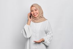 Asian Muslim woman having a nice conversation on her cell phone