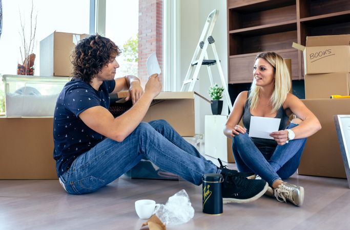 Couple unpacking moving boxes