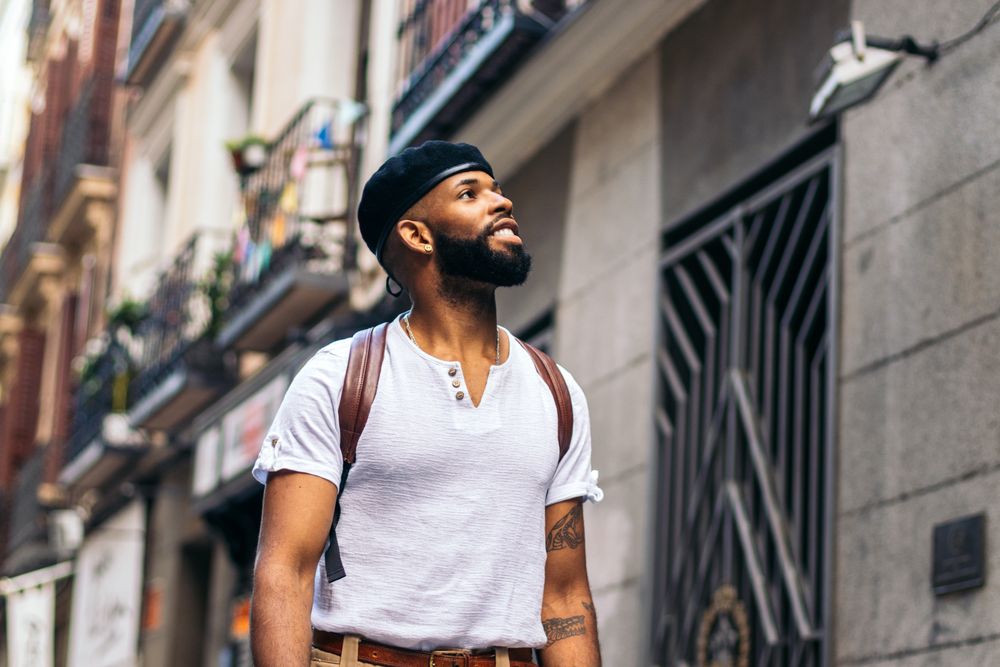 Stylish Black man walking on the city street