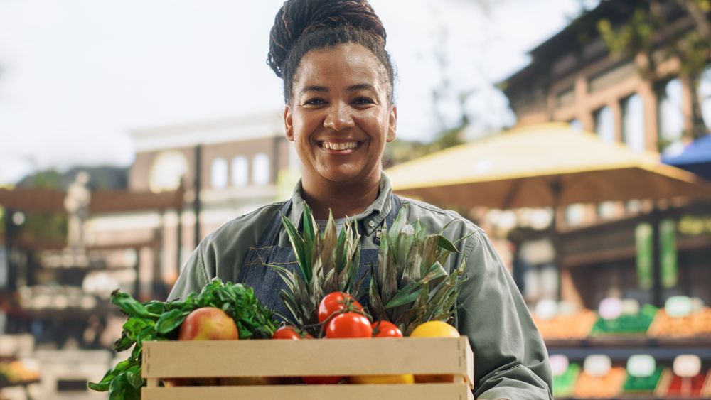 Portrait of a Black Female Working at a Farmers Market Stall with Fresh Organic Agricultural Products