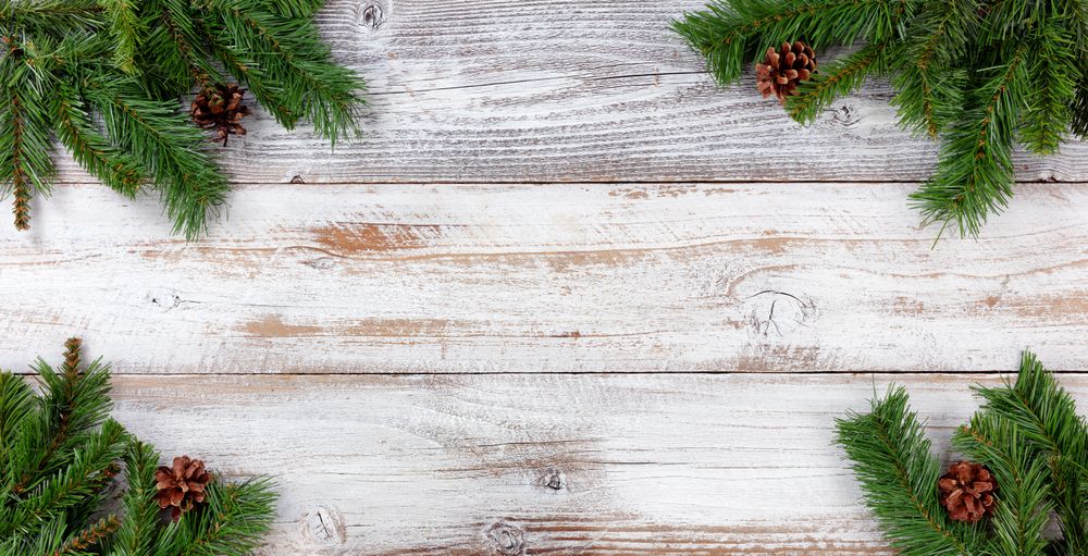 Christmas Evergreen branch decorations in all corners on vintage wooden boards