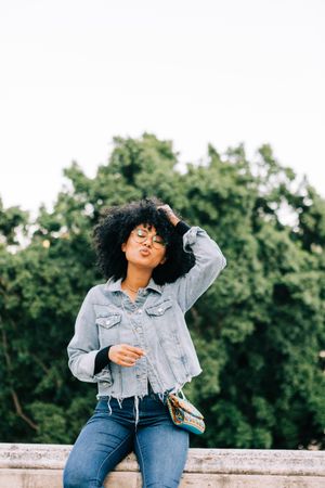 Fashionable Black female relaxing in city