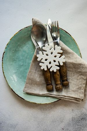 Pastel plate with cutlery and snowflake ornament