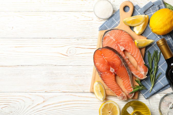 Composition with salmon meat and spices on wooden background, top view
