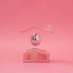 Pink disco ball Easter egg above minimalistic house