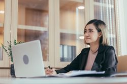 Calm employee sitting in her office