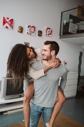 Multiracial couple having fun at home