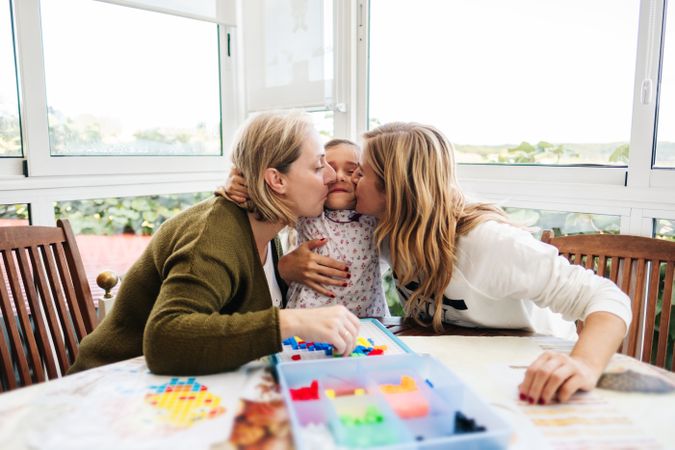 Woman playing board game with daughter and granddaughter