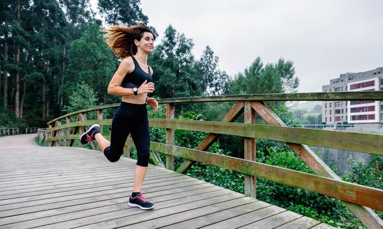 Woman running through an urban park