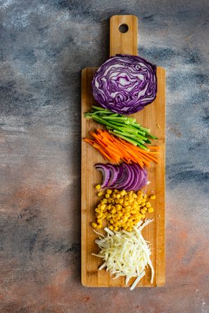 Cutting board of fresh ingredients for salad