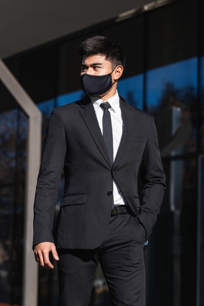 Asian businessman standing in street