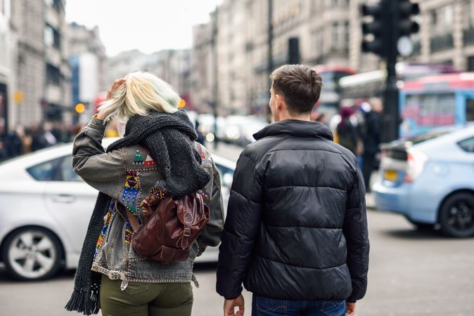 Back of man and woman walking in London