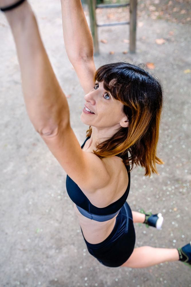 Woman doing monkey exercises on rings