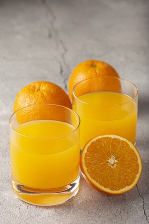Glass with orange juice on the table.