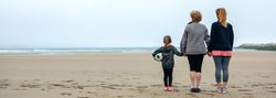 Three generations of women watching the sea