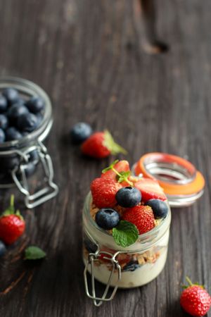 Pot of Greek yogurt parfait with strawberries, blueberries and granola