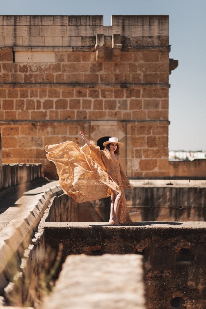 Stylish female on old bridge