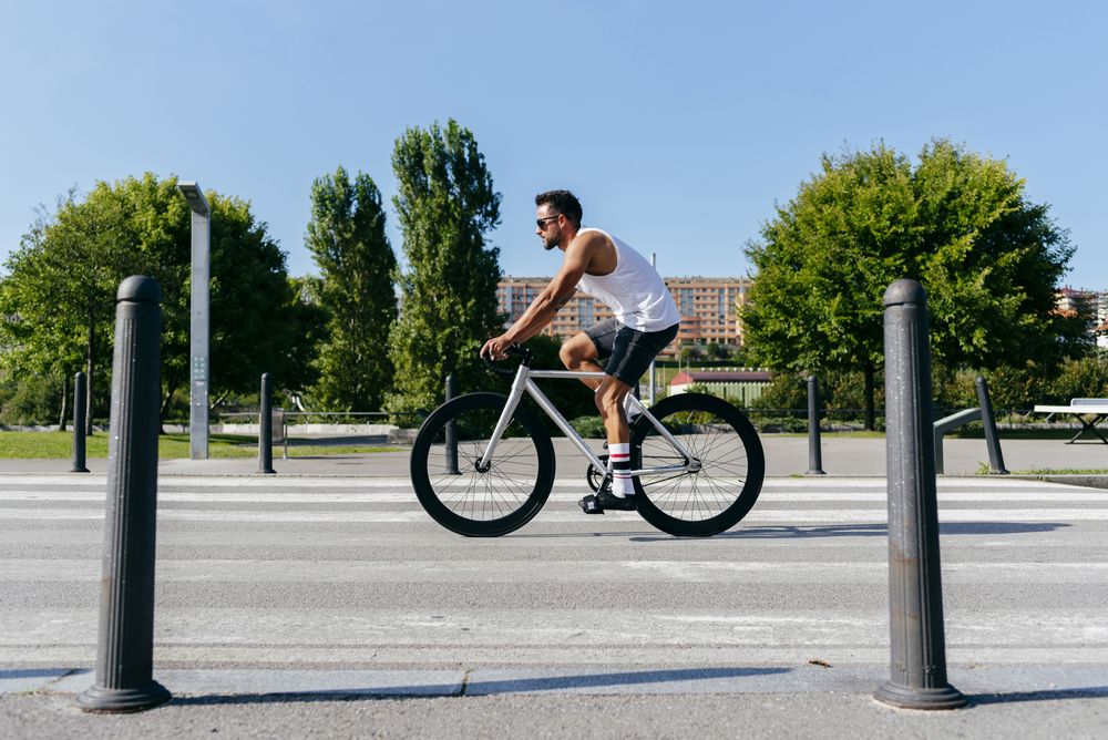 Man riding bicycle on city roadway