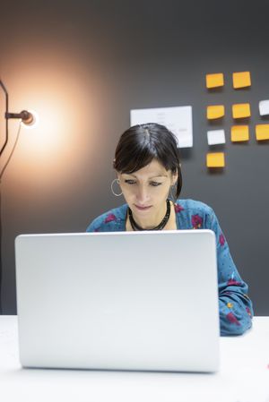 Smiling businesswoman working with laptop