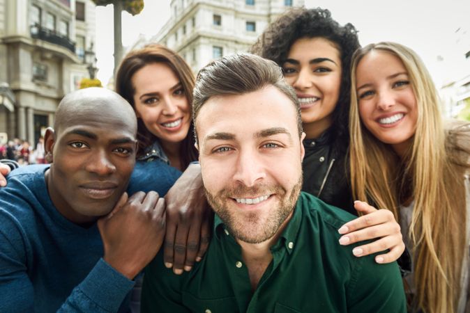 Smiling group of friends posing for selfie