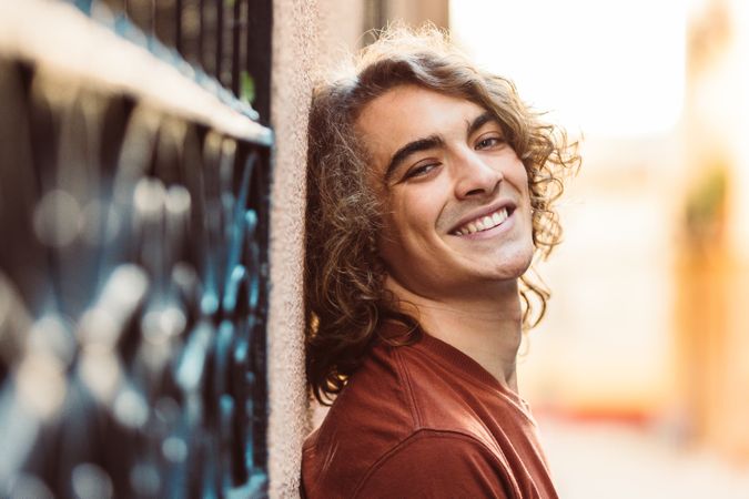 Positive handsome man smiling on street