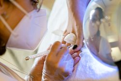 Toe nails being painted in nail salon