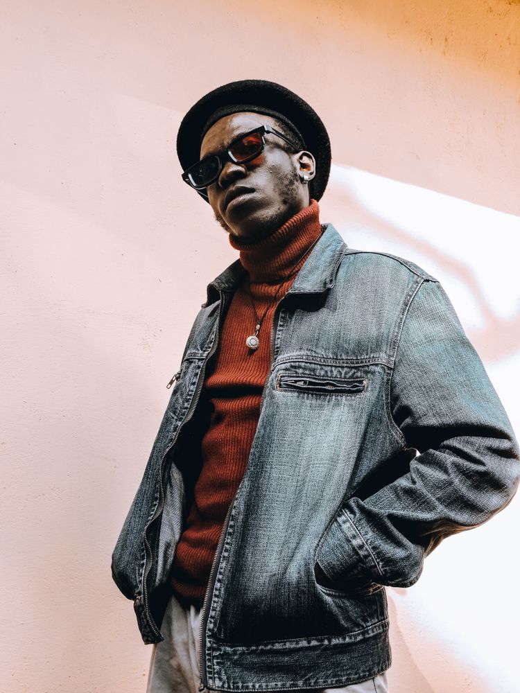 Man wearing sunglasses and hat and jacket