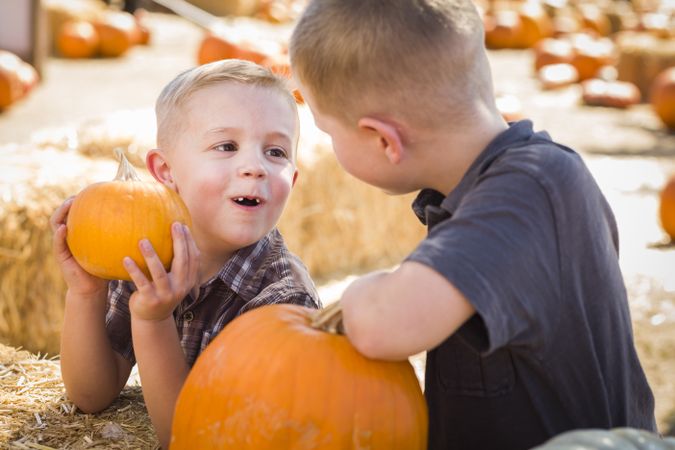 Two Boys at the Pumpkin Patch Talking and Having Fun.