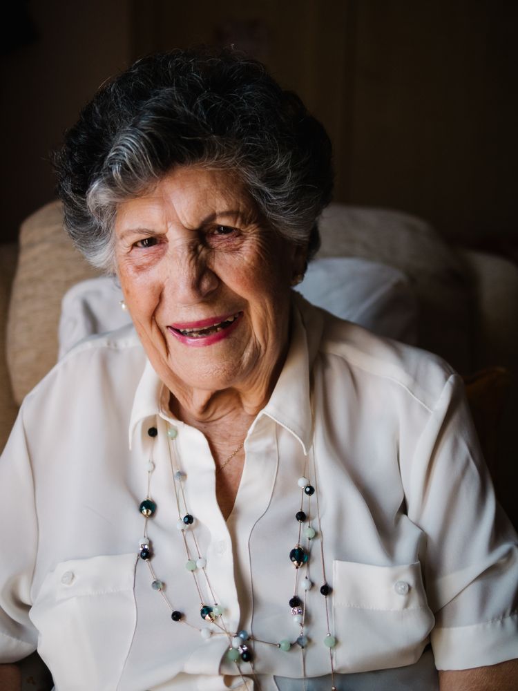 Portrait of older female in white shirt at home