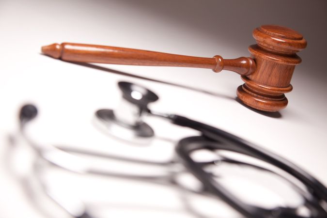 Gavel and Stethoscope on Gradated Background