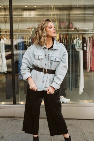 Trendy woman looking at shop window