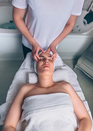 Woman receiving a relaxing facial massage