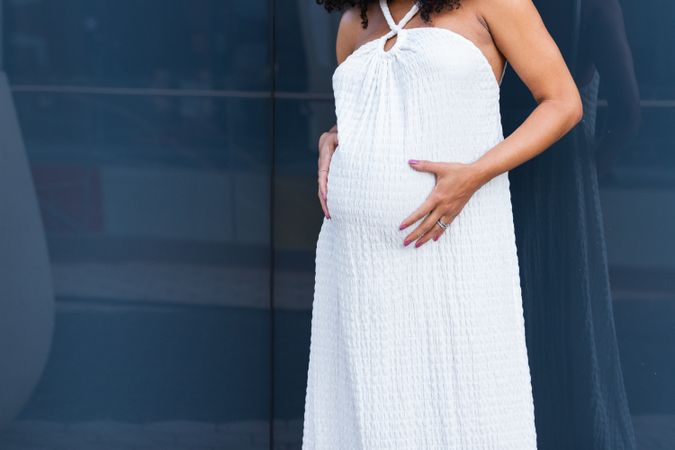 Anonymous pregnant woman in long dress