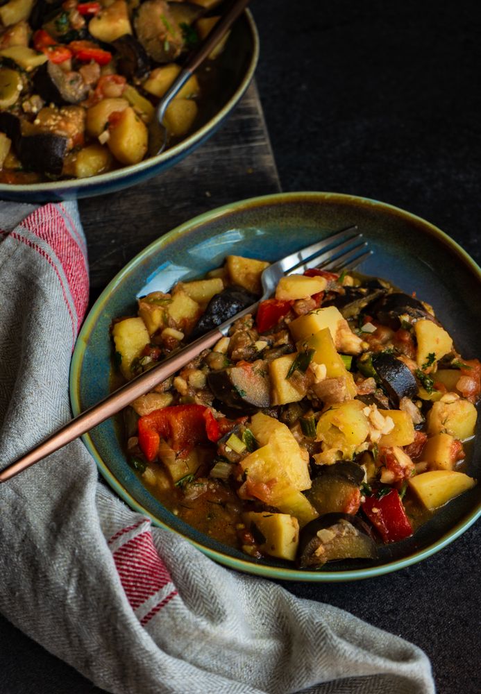 Popular Georgian summer and autumnal dish Ajapsandali with vegetables on stone background with copy space