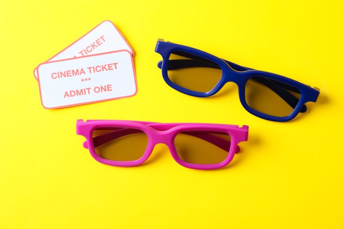 3d glasses and tickets on yellow background, space for text