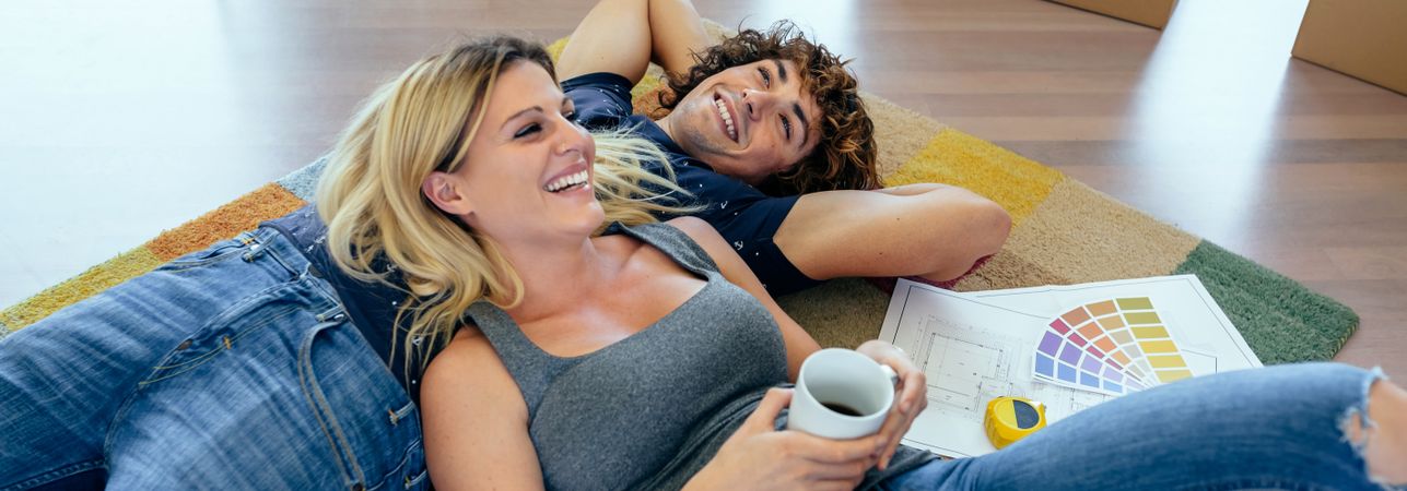 Couple resting lying on the carpet