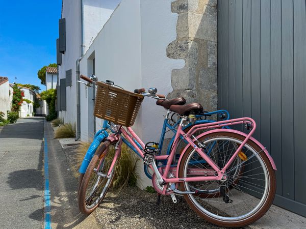 Blue and Pink bicycles on Rue des Pêcheurs, ile de ré, France