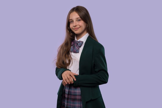 Young girl in school uniform posing confidently