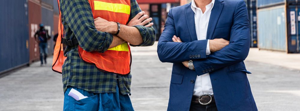 Banner of torsos of two men working at shipping container site