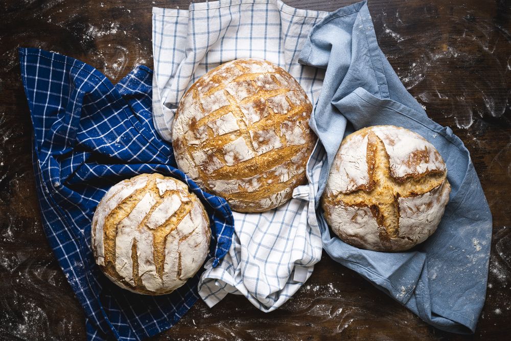 Whole loaves of sourdough on a baker counter