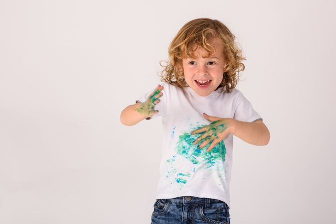 Cheerful boy with dirty t shirt
