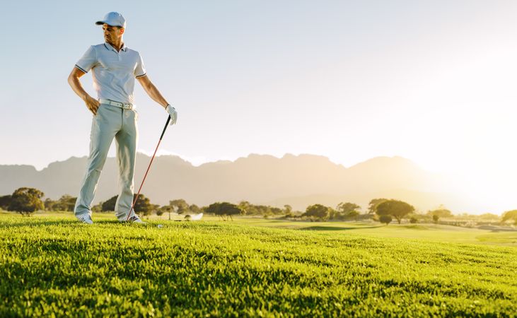 Athletic male thinking about next shot on golf course