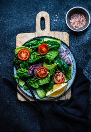 Top view of spinach salad with cherry tomatoes