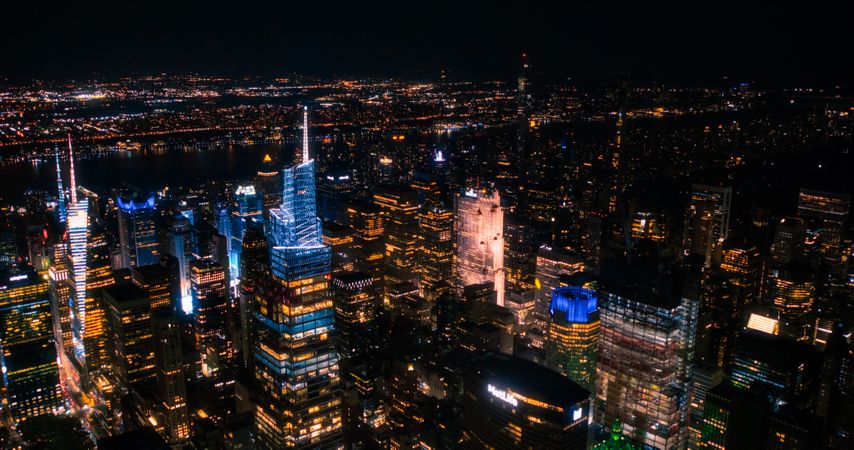 Helicopter Tour of New York City Architecture at Night. Midtown Manhattan Office Buildings and Skyscrapers Towards Madison Square Garden. Aerial Urban Landscape with Lights in the Evening