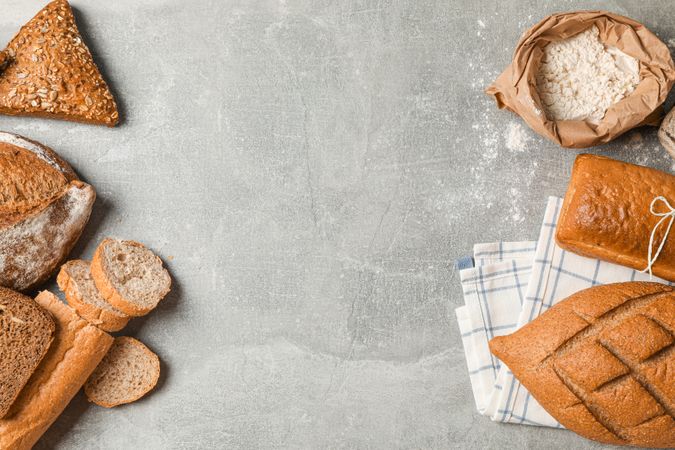 Bakery products composition on grey background, top view and space for text